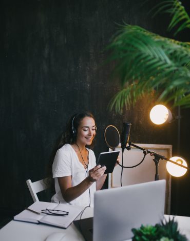 young-woman-blogger-recording-podcast-using-microp-7RY7EAM-1.jpg